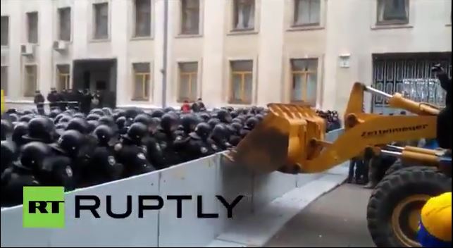 Ukrainian protestors know how to break through a police line. They steal a digger
